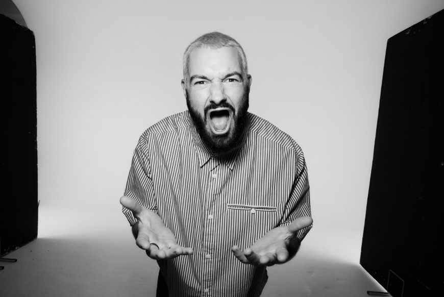 a man in black and white screaming into the camera